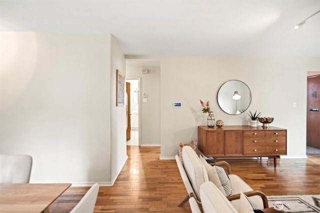 hallway with baseboards and light wood finished floors