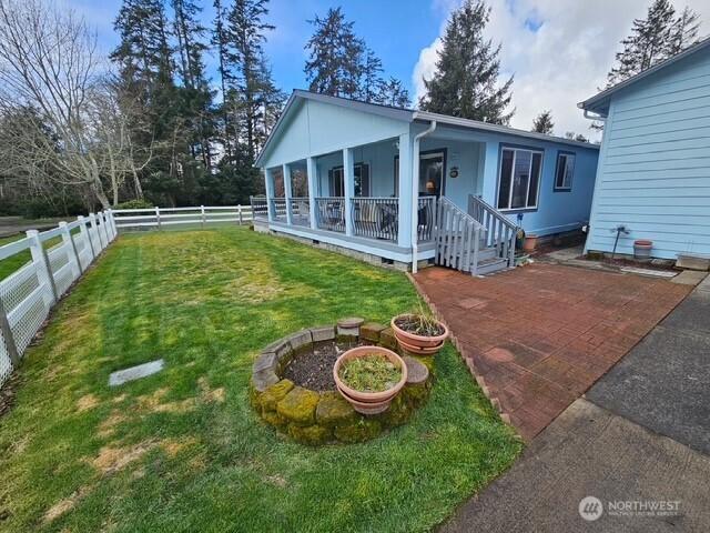 exterior space with crawl space, a yard, a porch, and a fenced backyard