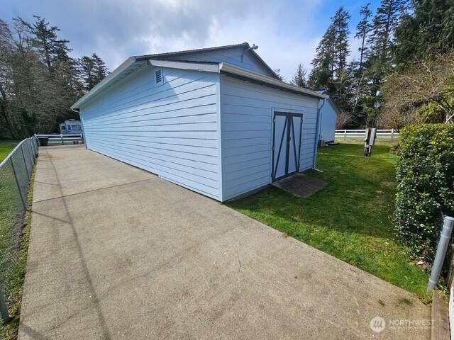 view of outbuilding with an outdoor structure and fence