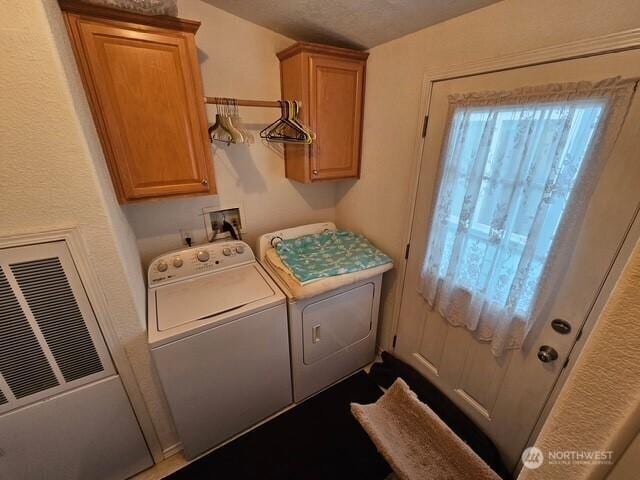 laundry room featuring cabinet space, separate washer and dryer, and a heating unit