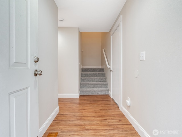 stairs with baseboards and wood finished floors