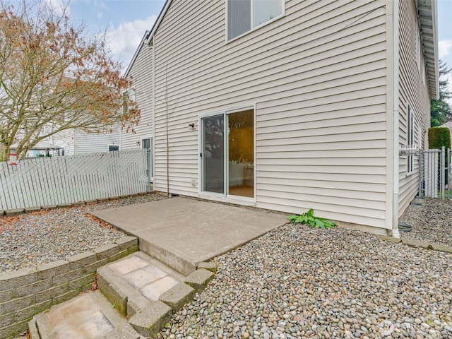 rear view of house featuring a patio and fence