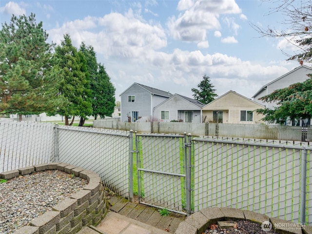 exterior space featuring fence and a gate