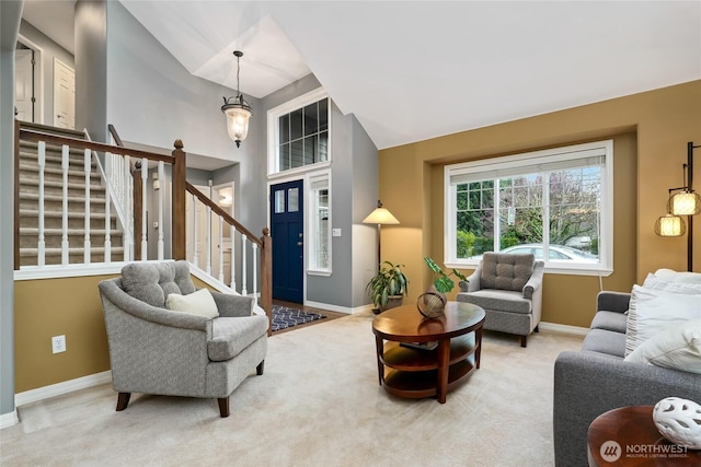 living area with stairs, vaulted ceiling, carpet flooring, and baseboards