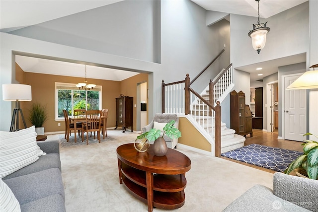 living room featuring stairway, baseboards, light colored carpet, and a high ceiling