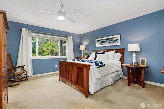 bedroom featuring a ceiling fan, light colored carpet, and baseboards