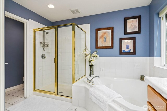 full bathroom featuring tile patterned floors, visible vents, toilet, a stall shower, and a bath