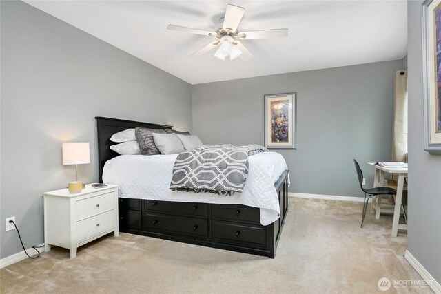 bedroom with ceiling fan, baseboards, and light carpet