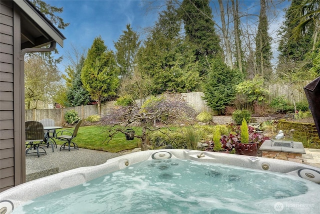 view of swimming pool featuring a fenced backyard, a patio, and an outdoor hot tub