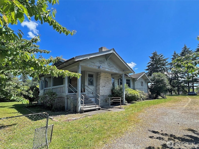 3320 90th St S, Lakewood, WA 98499 - bungalow-style home with a chimney, a porch, a front lawn, and fence