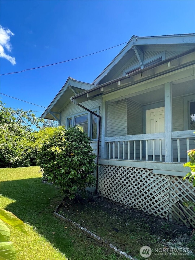 3320 90th St S, Lakewood, WA 98499 - view of side of home with a porch and a lawn