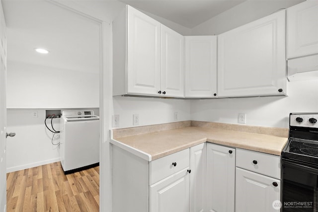 kitchen featuring light wood-style flooring, electric stove, white cabinetry, light countertops, and washer / dryer