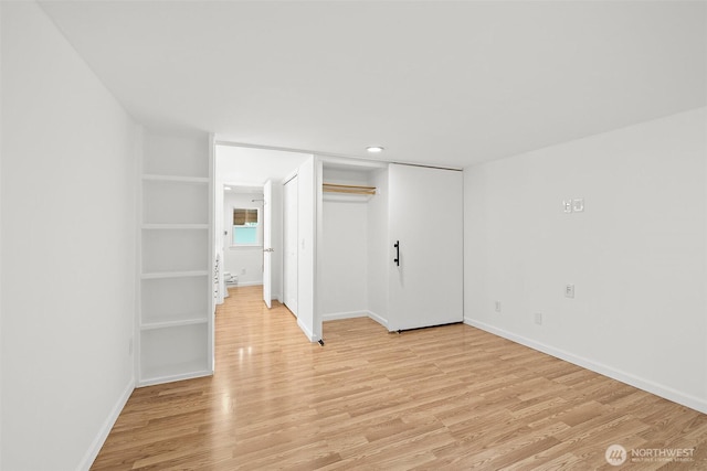 empty room with baseboards and light wood-type flooring