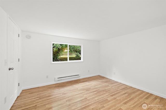 empty room featuring light wood-style floors, baseboards, and a baseboard radiator