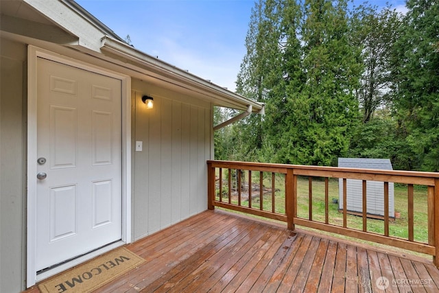 wooden deck featuring a lawn