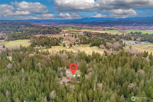 birds eye view of property featuring a wooded view