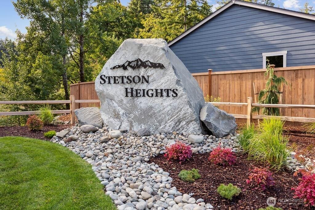 community / neighborhood sign with fence