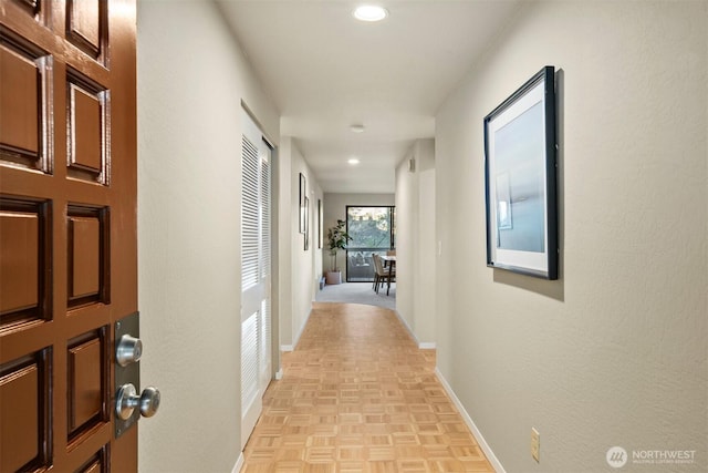 corridor featuring recessed lighting and baseboards