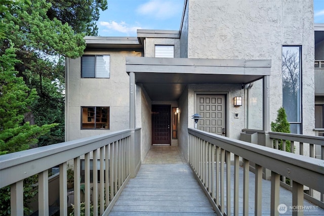 entrance to property with stucco siding