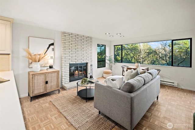 living area with recessed lighting, a baseboard radiator, baseboards, and a fireplace