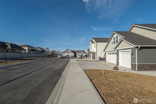 view of street featuring a residential view, curbs, and sidewalks