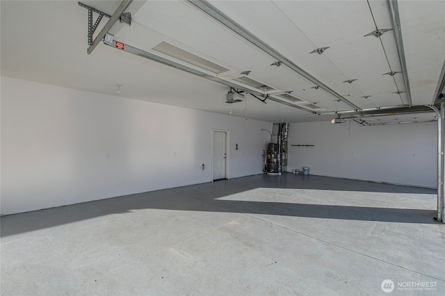 garage featuring strapped water heater and a garage door opener