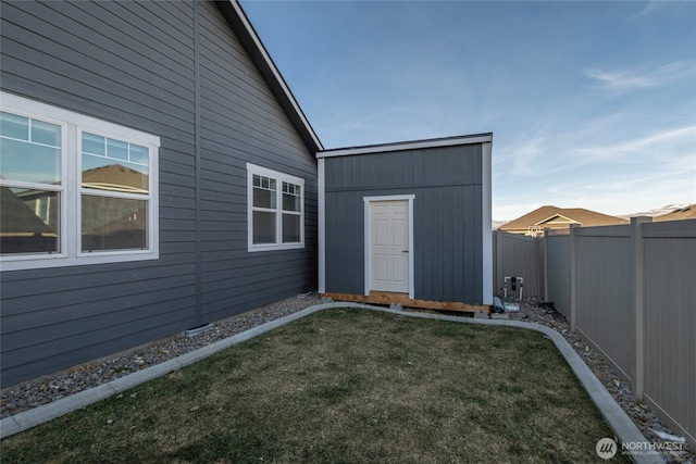 exterior space with an outbuilding and a fenced backyard