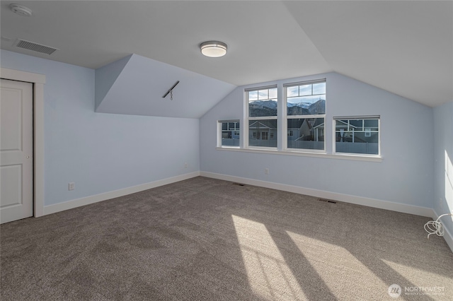 bonus room featuring vaulted ceiling, baseboards, visible vents, and carpet floors