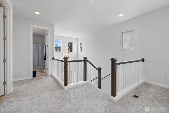 hallway featuring recessed lighting, an upstairs landing, baseboards, and carpet floors