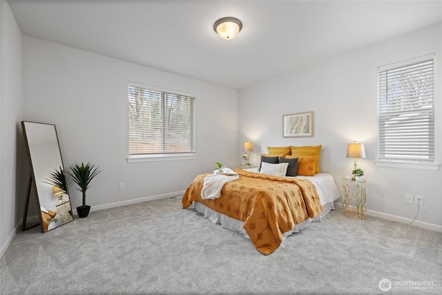 bedroom with multiple windows, carpet floors, and baseboards