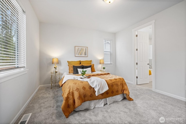 carpeted bedroom featuring visible vents and baseboards