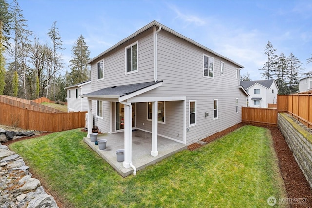 back of property featuring a patio, a lawn, and a fenced backyard