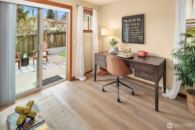 office space with baseboards and wood finished floors