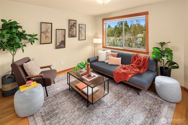 living area with wood finished floors and baseboards