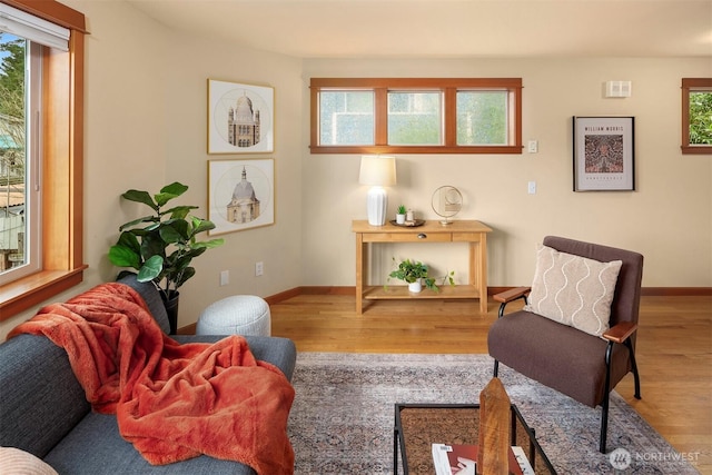 living area with wood finished floors and baseboards