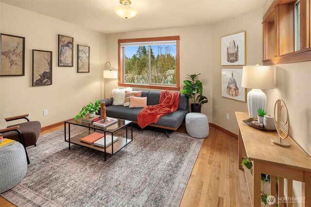 living room featuring light wood finished floors and baseboards