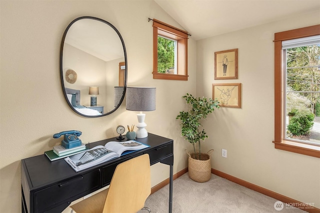 home office featuring lofted ceiling, carpet flooring, baseboards, and a wealth of natural light