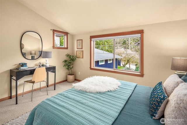 bedroom with carpet, baseboards, and vaulted ceiling