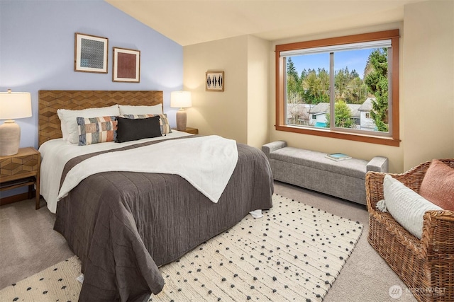 bedroom featuring lofted ceiling and light colored carpet