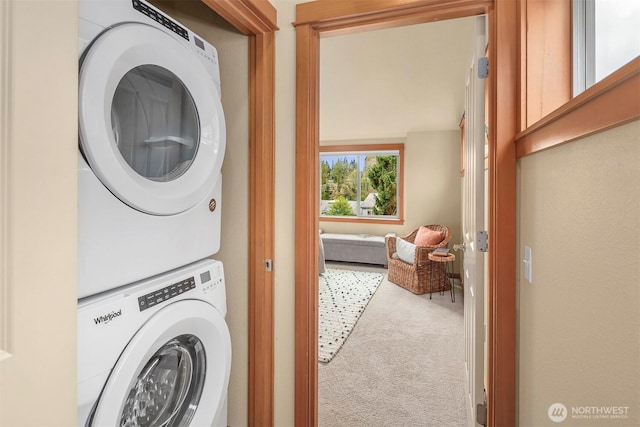 laundry room featuring carpet, laundry area, and stacked washing maching and dryer