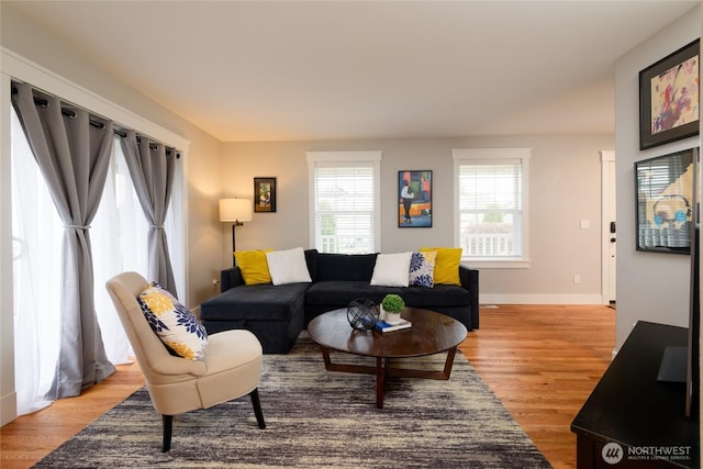 living room with light wood-style flooring and baseboards