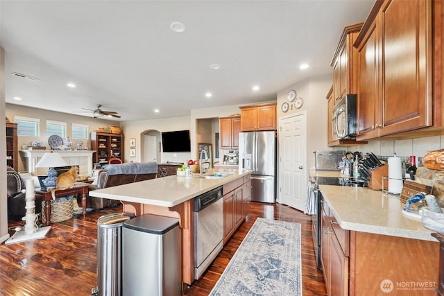 8107 165th Street Ct E, Puyallup, WA 98375 - kitchen with open floor plan, brown cabinets, and appliances with stainless steel finishes