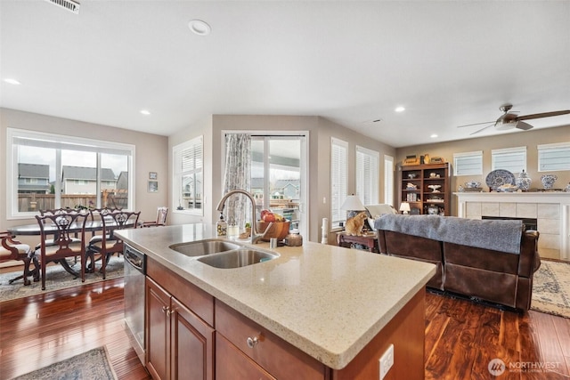 8107 165th Street Ct E, Puyallup, WA 98375 - kitchen with brown cabinets, ceiling fan, a sink, and dark wood-type flooring