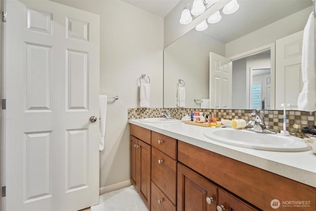8107 165th Street Ct E, Puyallup, WA 98375 - full bath with double vanity, backsplash, baseboards, and a sink