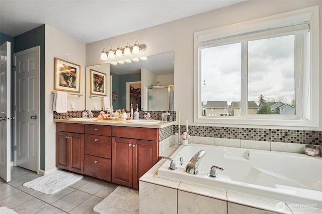 8107 165th Street Ct E, Puyallup, WA 98375 - bathroom with decorative backsplash, a shower stall, double vanity, tile patterned floors, and a garden tub