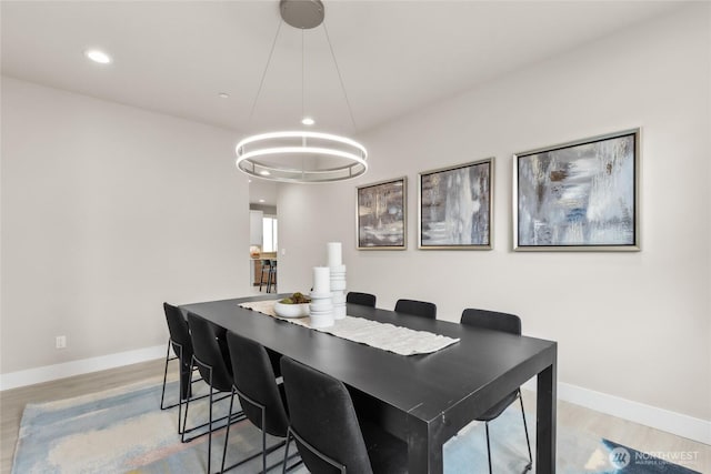 dining area with recessed lighting, baseboards, and wood finished floors