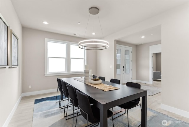 dining room featuring recessed lighting, french doors, baseboards, and light wood-style flooring