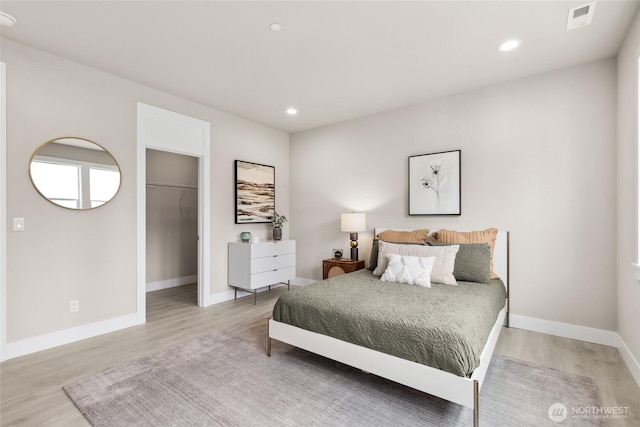 bedroom with recessed lighting, baseboards, visible vents, and light wood-type flooring