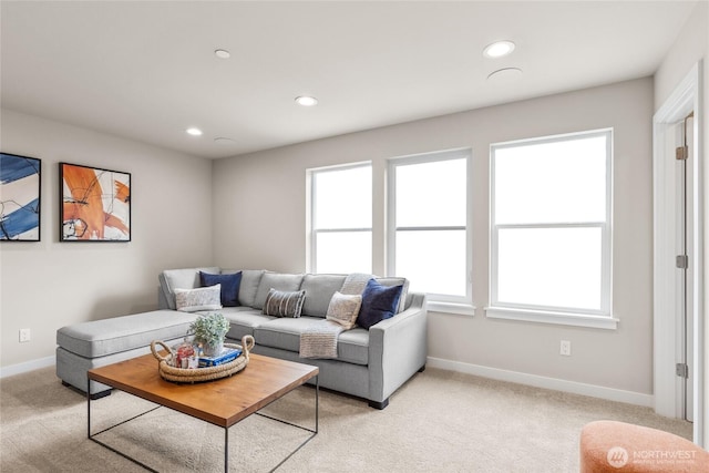 living area featuring recessed lighting, baseboards, and light colored carpet