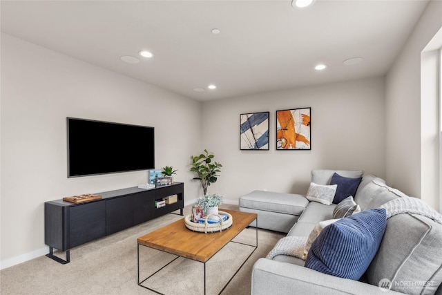 living room featuring recessed lighting, baseboards, and light colored carpet